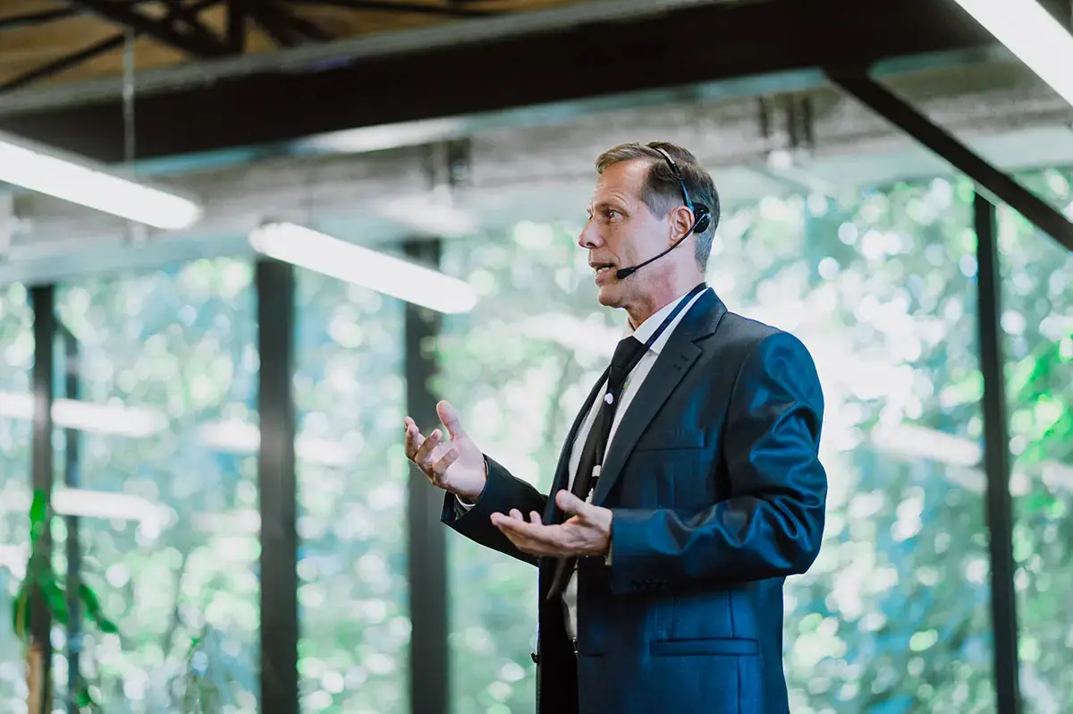 Cinematic image of a conference meeting. Business people sitting in a room listening to the motivator coach. Representation of a Self growth and improvement special event