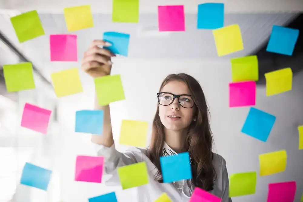 young-girl-business-woman-glasses-watch-transperent-wall-with-lot-paper-stickers-it-1